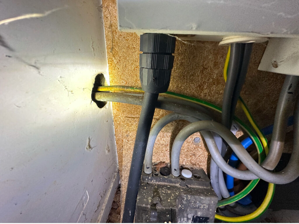 Effective Mouse Control in a Large Detached House this image shows how the mice got into the Northampton home, there is a hole where the utility wires go into the property, this gap is big enough for a mouse to carwl into and access the property